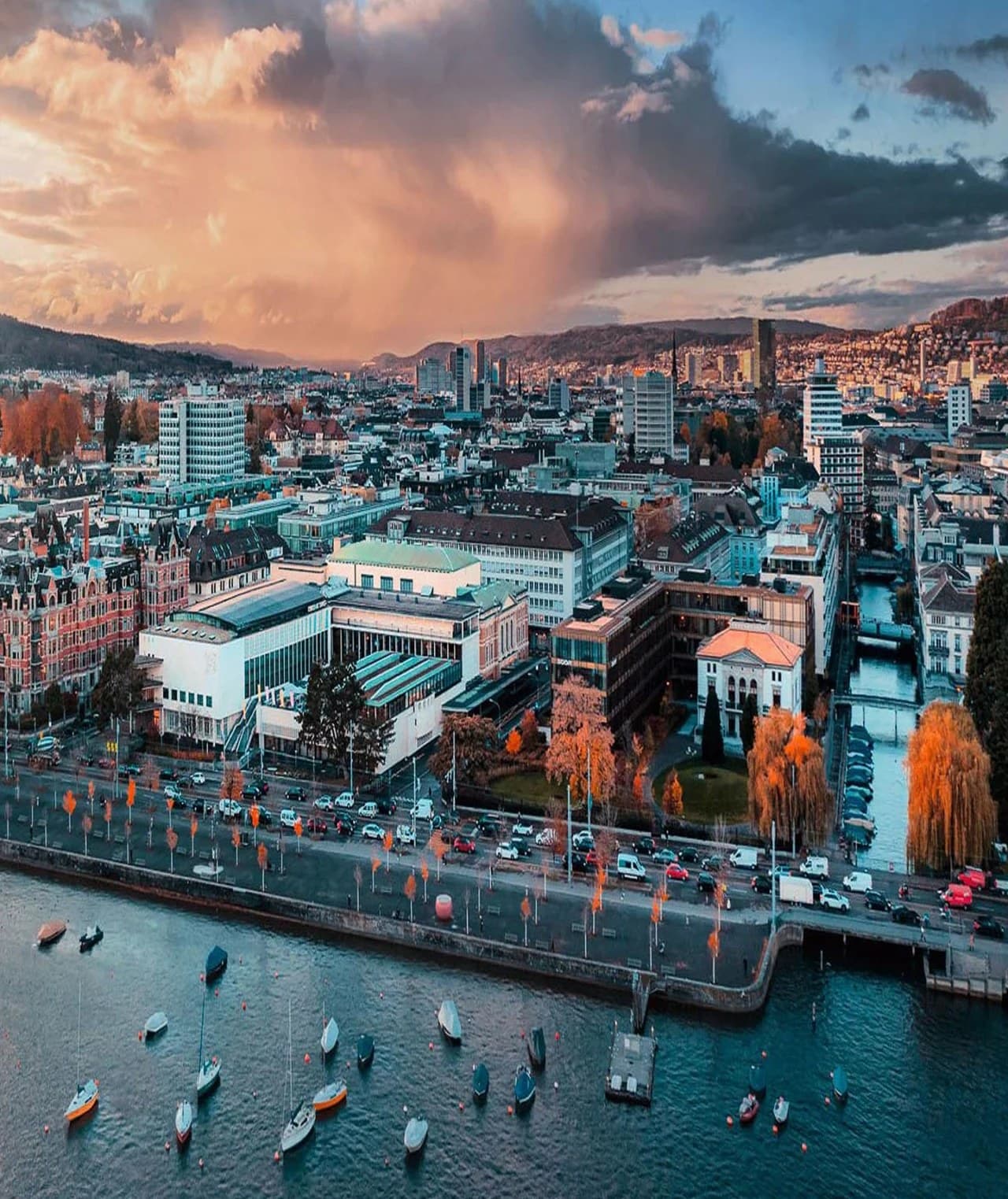Zurich's lakefront from the air at sunset, with boats moored on the lake