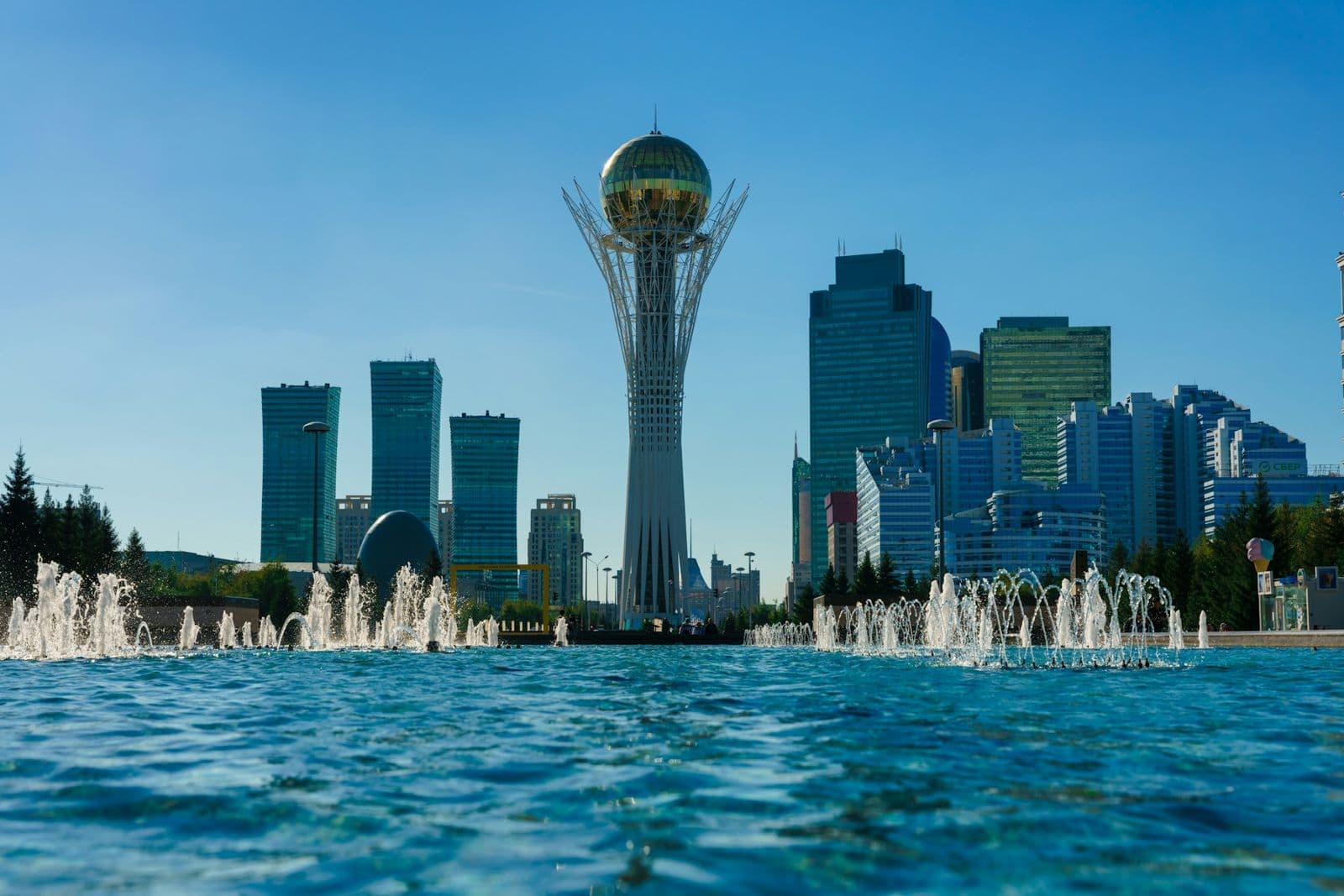 Astana's Baiterek Tower and skyline beyond a fountain