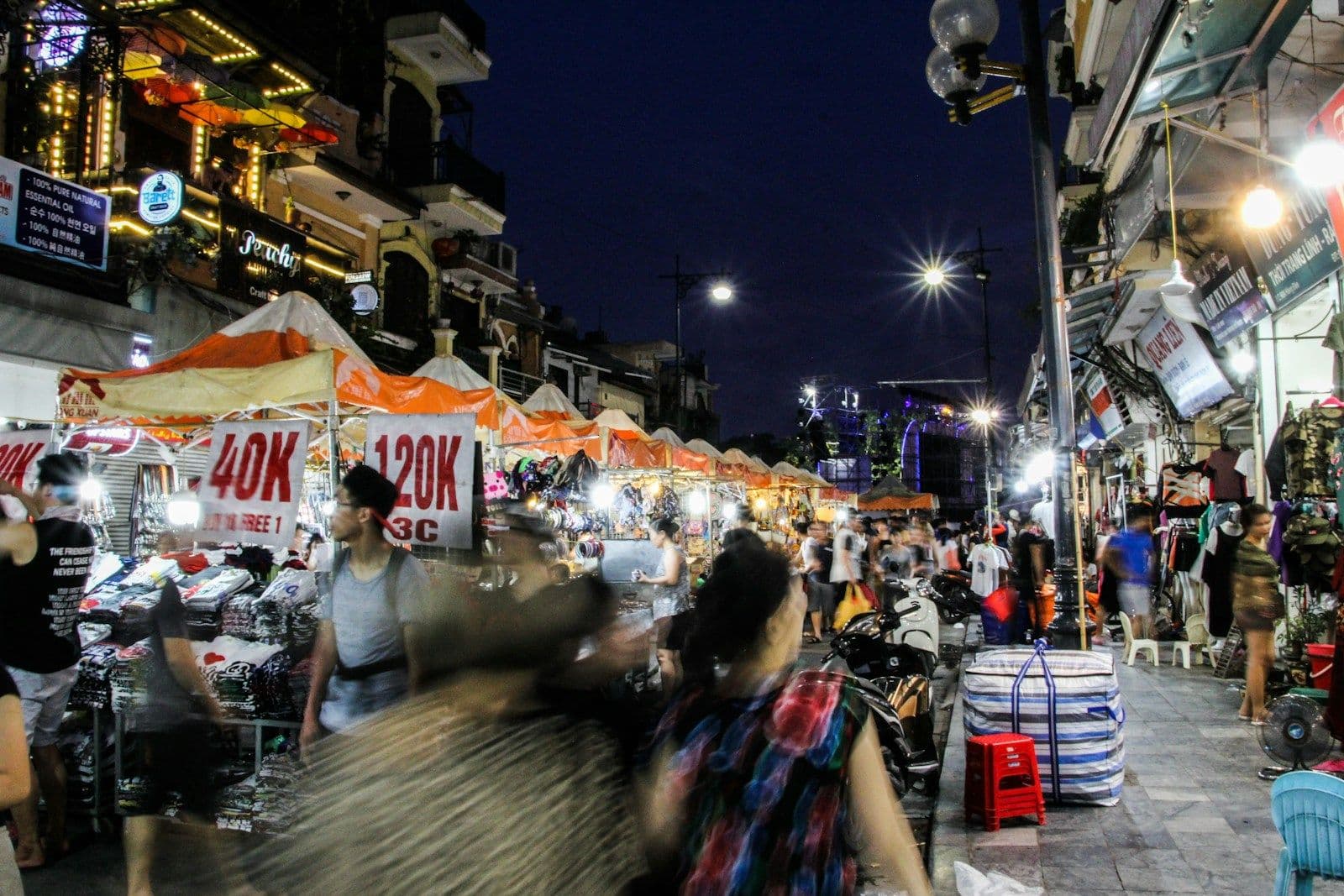 Shoppers at a busy street market at night