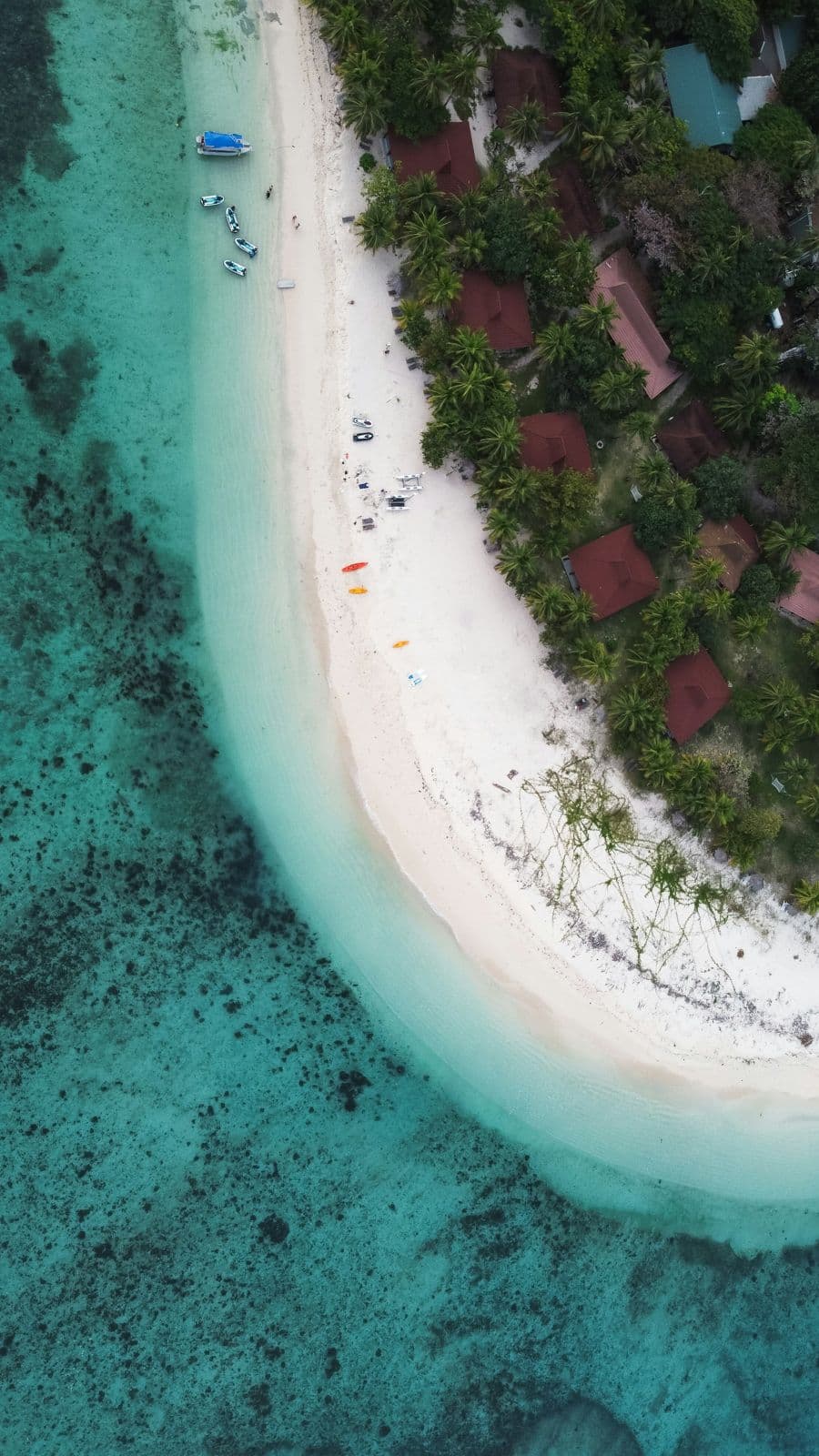 A white-sand island beach and turquoise water from above