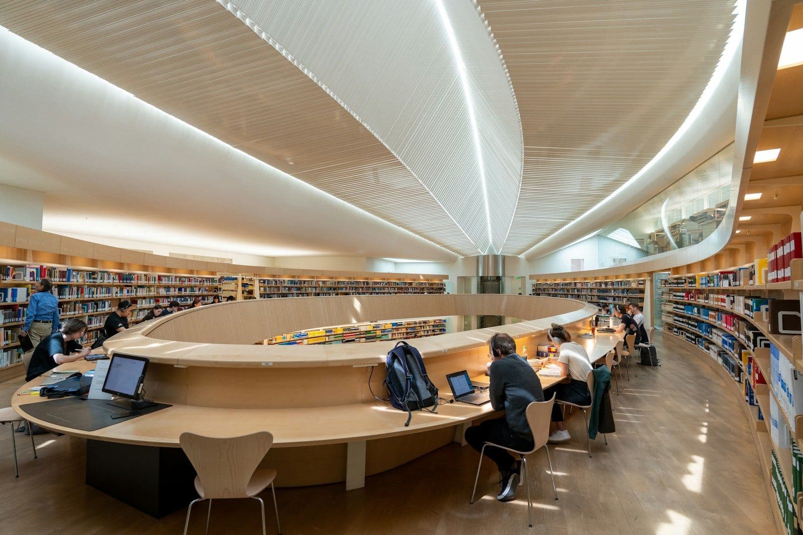 Students working at desks in a modern university library