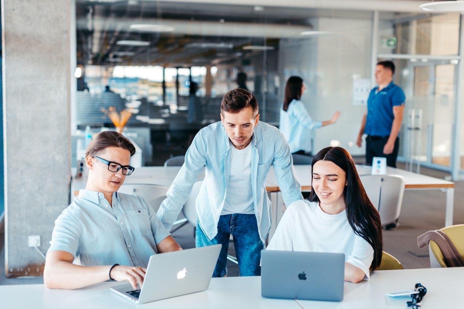 A team working together at laptops in a bright office
