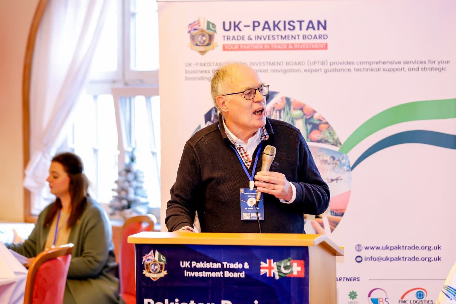 A speaker addressing delegates from the UK-Pakistan Trade & Investment Board lectern
