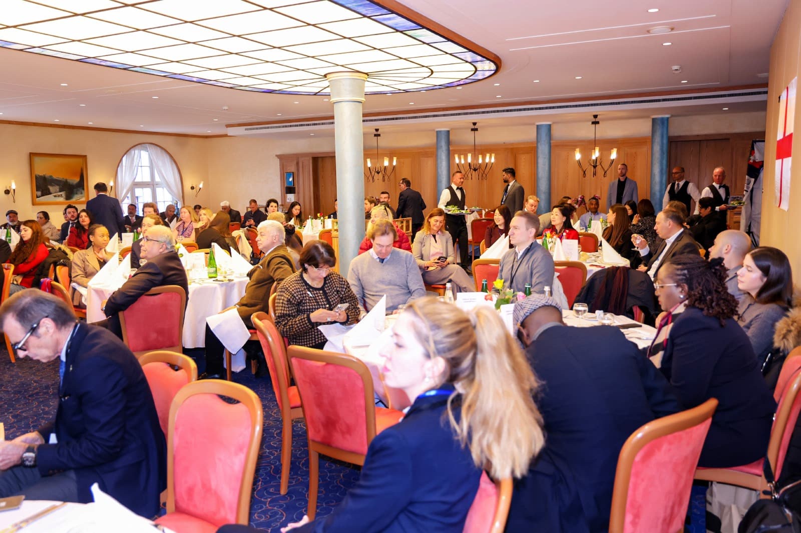 Delegates at round tables in the summit hall in Zurich