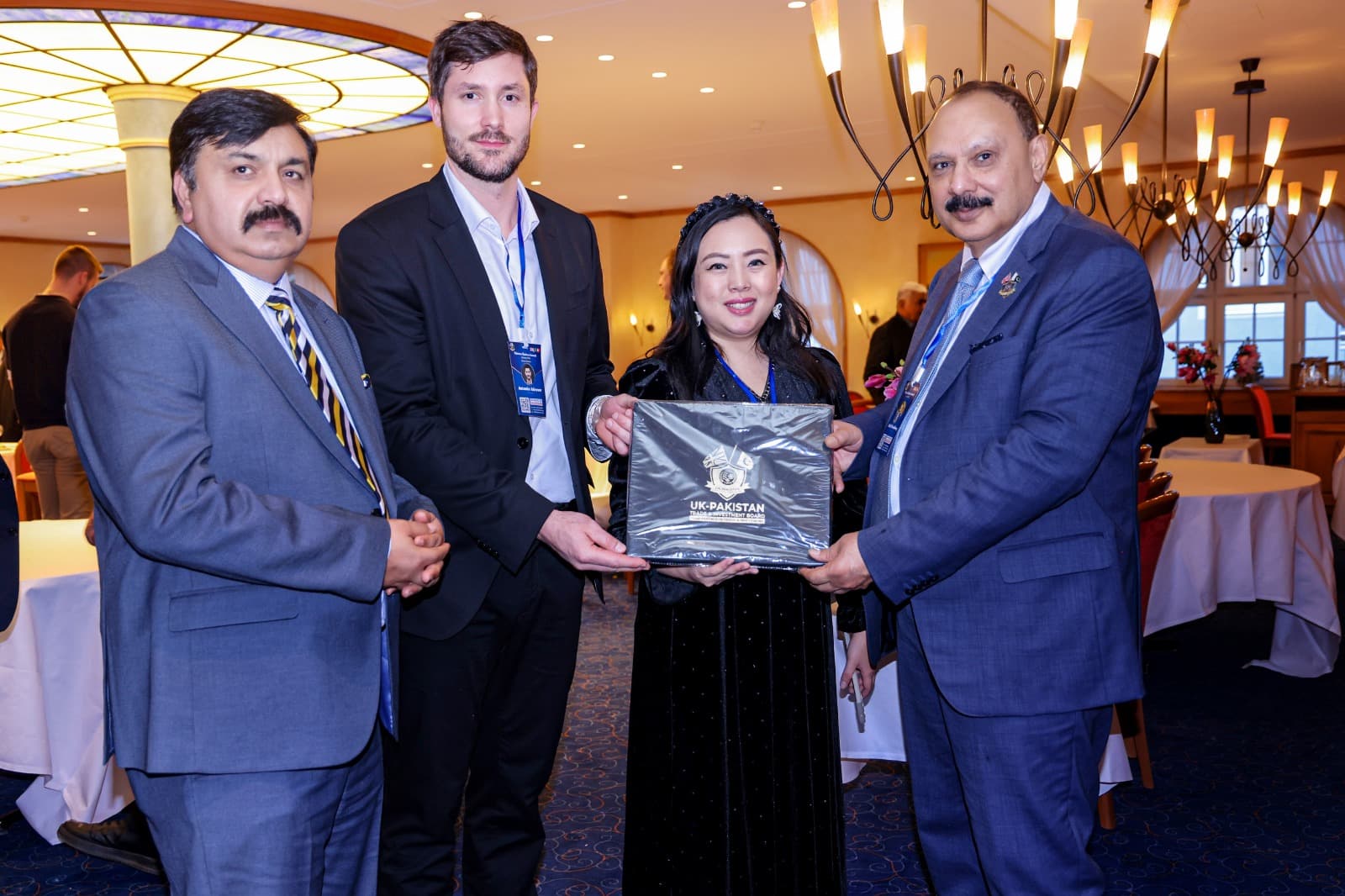 An honoree receiving a presentation from the organisers in the summit hall