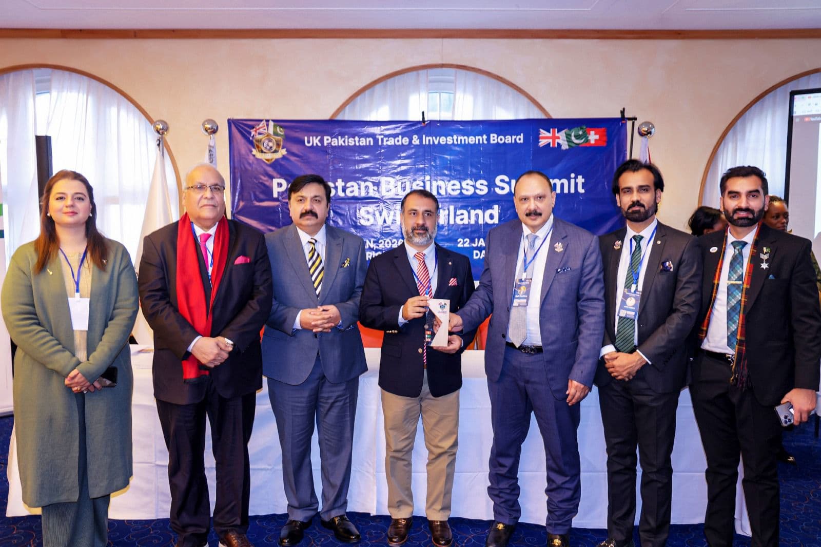An honoree with his award and the presenting delegation