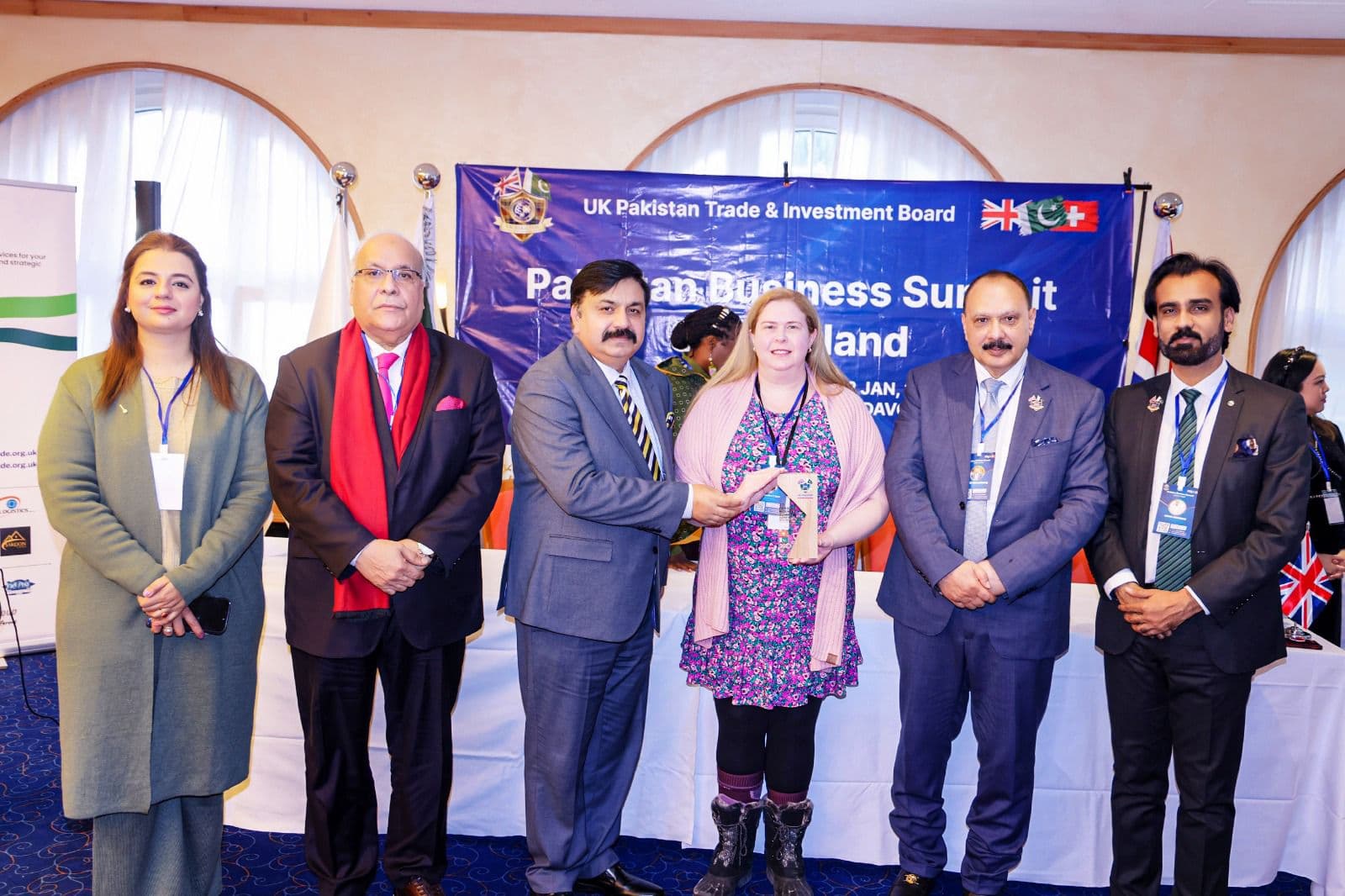 An honoree holding her award among the presenters
