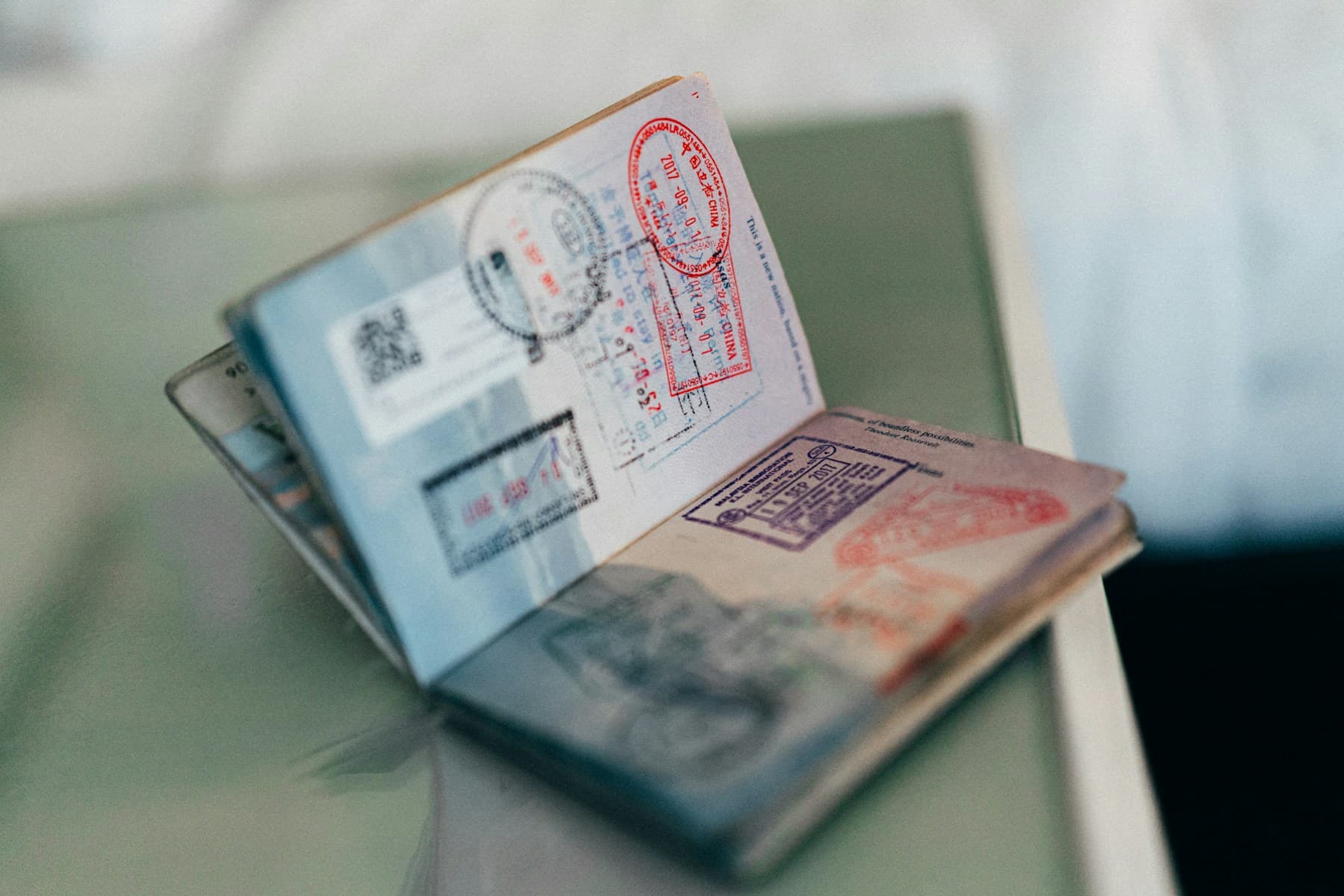 An open passport with entry stamps
