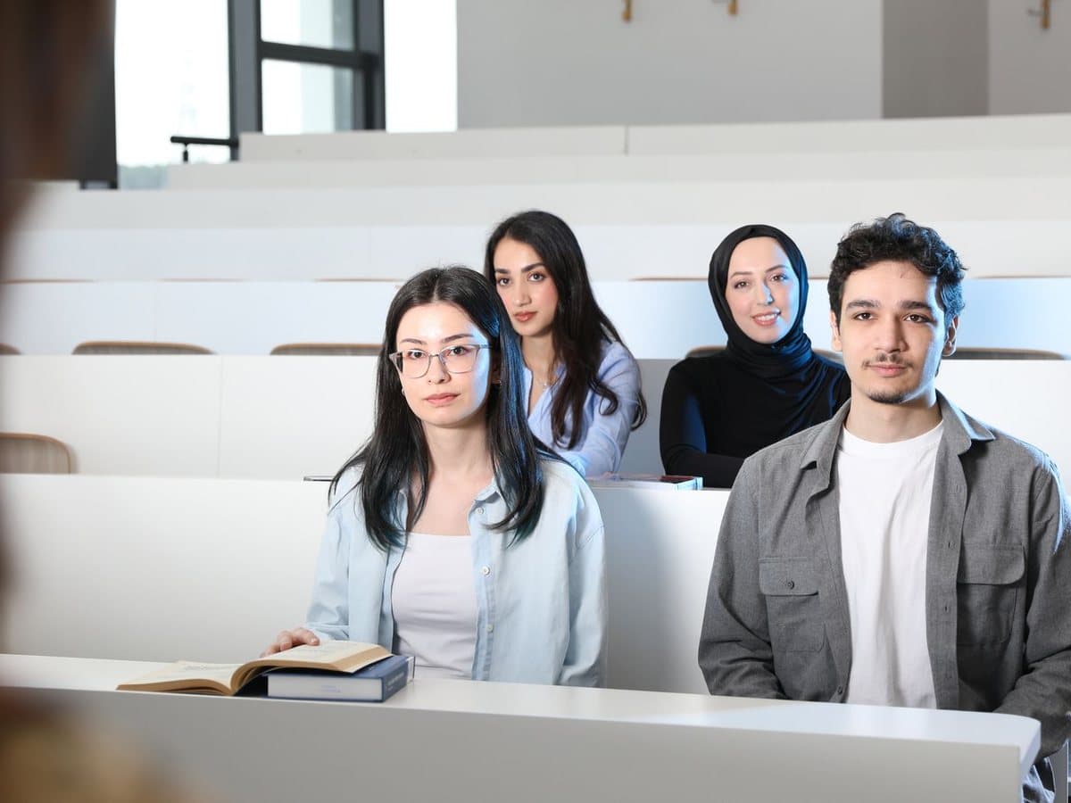 Four students seated in a lecture hall