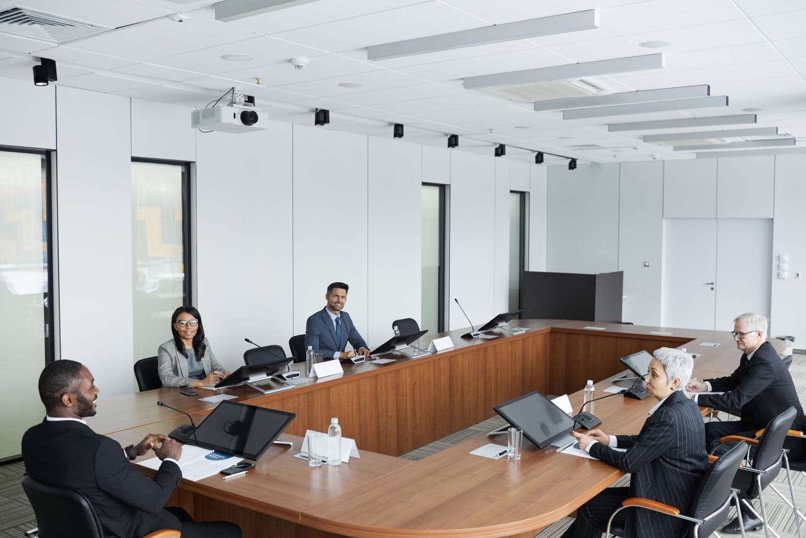 A delegation in discussion around a boardroom table