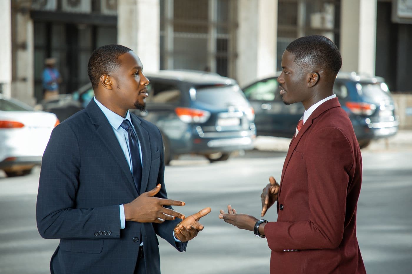 Two businessmen in conversation on a city street